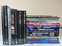 Group shot of all upright and stacked Star Trek books showing spines
