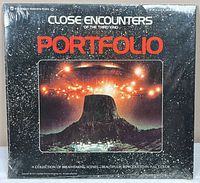Front of sealed Close Encounters portfolio showing cover art and title