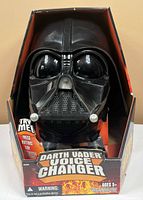 Front view of Darth Vader voice-changer helmet in open box