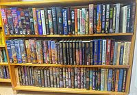 Full view of two book-shelf rows showing quantity and variety of hardcover fantasy & sci-fi books