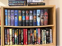 Wide shot of two shelves showing majority of upright hardcover spines