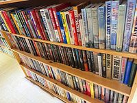 Two shelves filled with hardcover mystery and naval fiction titles