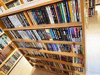Full shelf of mass market sci-fi and fantasy paperbacks