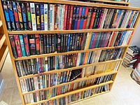 Front view of six-shelf bookcase filled with paperbacks