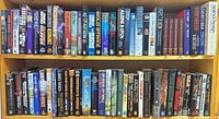 Full view of two shelves packed with assorted science fiction and fantasy books