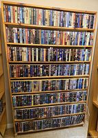 Full bookshelf showing five packed rows of paperbacks