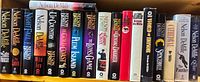 Full shelf view of all Nelson DeMille hardcovers