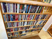 Front view of five shelves filled edge-to-edge with mass-market paperbacks