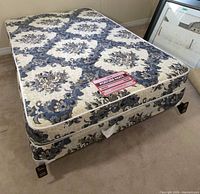 Mattress, box spring stacked on metal bed frame with casters