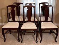 Front view of all six chairs showing design, finish, upholstery