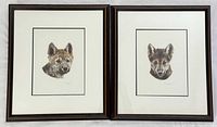 Both framed wolf pup prints side by side
