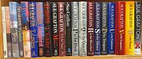 Shelf view showing full run of Sue Grafton hardcovers A through X and duplicates