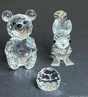 Front view of all three figurines: bear, squirrel, small round figure