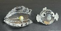 Both Swarovski crystal pieces side by side: puffer fish and faceted base with pearl