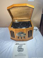 Console open showing turntable and manual