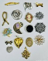 Group shot of all 17 brooches arranged in rows