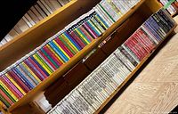 Two shelves filled with mass-market paperbacks, top shelf Ace SF coloured spines, lower shelf white Perry Rhodan