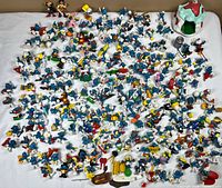 Full collection overview of numerous Smurf figures, accessories, and mushroom house