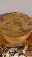 Top view of bentwood cheese box showing handwritten marking and distressed surface