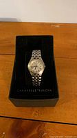 Watch in original box showing dial, bracelet, and branding