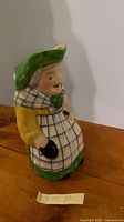 Front view of handpainted ceramic Toby jug showing colors and figure detail
