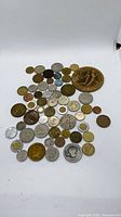 Full grouping of assorted coins and medal on white background