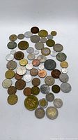 Full set of assorted coins spread on white background
