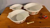 Three graduated Pyrex orange blossom milk glass mixing bowls
