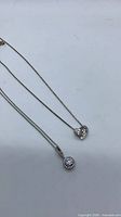 Front view of both sterling silver pendant necklaces