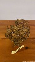 Brass filigree model sailing ship front view