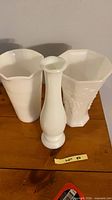 Front view showing all three milk glass vases