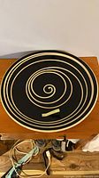 Top view showing black bowl with cream spiral pattern