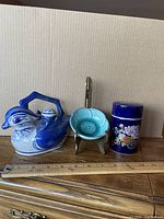 All three ceramic pieces with metal stand staged for size reference