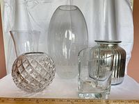 Five assorted clear and silver mercury glass vases displayed together