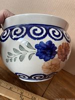 side view showing floral design and swirl rim