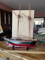 Full view of model sailboat on stand