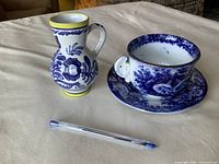 Teacup, saucer and pitcher/vase displayed together