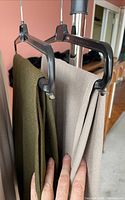 Two skirts hanging on rack, olive and taupe colors visible