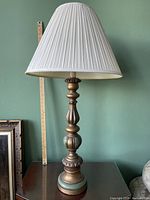 Full view of lamp with shade on tabletop