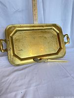 Brass tray and letter opener shown with ruler for scale