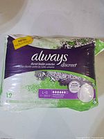 Front of sealed Always Discreet underwear package showing size L/G, 19 count