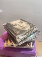 Stacked compact discs with Adele 25 album on top