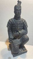 Front view of kneeling archer figurine showing armor detail and missing bow