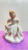 front view of Royal Doulton November figurine in white dress with floral trim