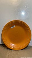 Front view of tangerine Fiesta dinner plate