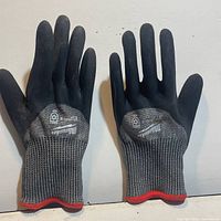 Front view of both pairs Milwaukee gloves showing logo and cuff trim