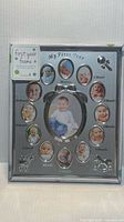 Front view of silver-tone baby first year picture frame showing all photo openings and tag