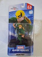 Front view of sealed Disney Infinity Iron Fist figure in packaging