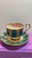 Teacup on saucer showing overall design, color, and gilding