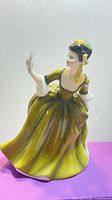 Front angled view of Simone figurine showing gown color and fan
